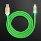 Green flexible USB to Lightning cable with gold-plated glowing LED housing.