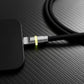 Close-up of black charging cable with glowing yellow connector