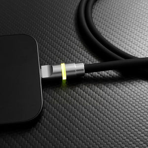 Close-up of black charging cable with glowing yellow connector