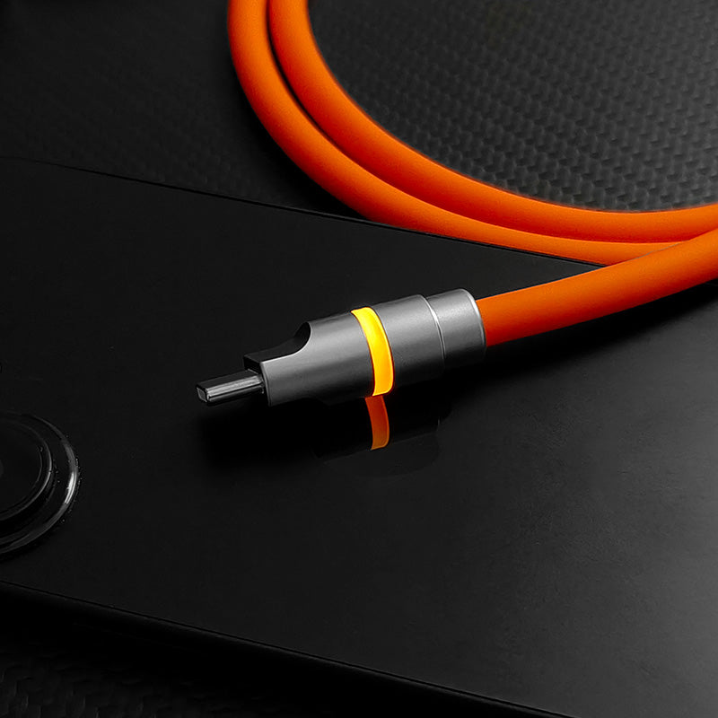 Close-up of orange charging cable with glowing amber connector