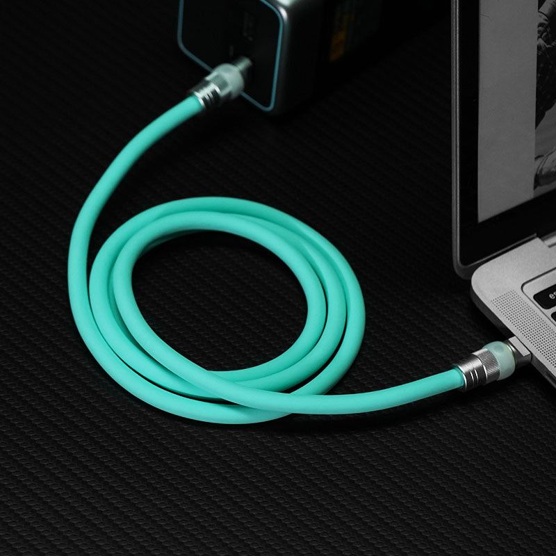 Mint green USB-C cable connecting power bank to laptop