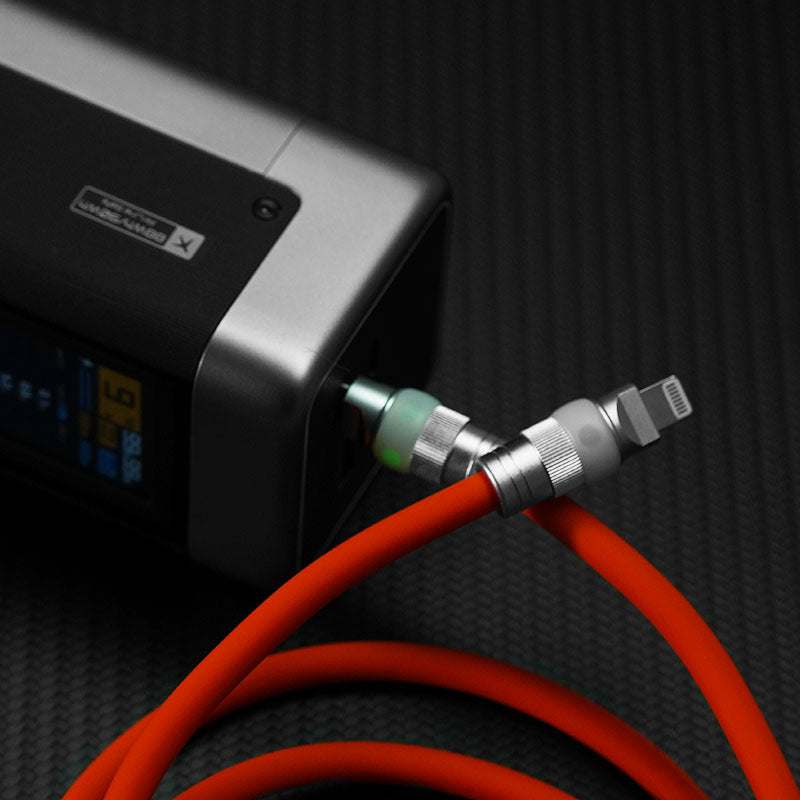 Orange Lightning cable plugged into high capacity power bank