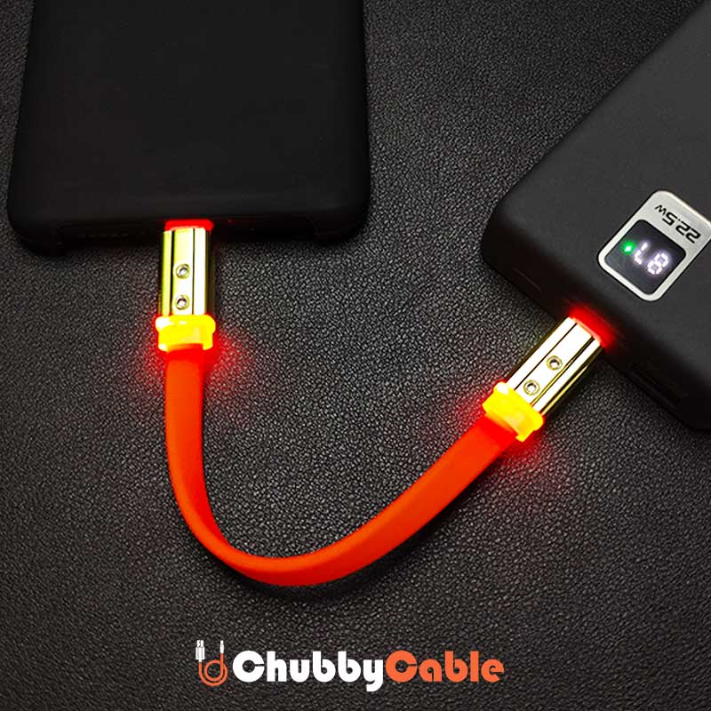 ChubbyCable orange LED glowing short power bank charging cable connected to phone