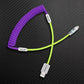 Purple coiled cable with lime green extension and USB-A to Lightning connector
