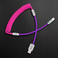 Pink coiled charging cable with purple straight section