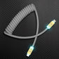Grey coiled USB-C to Lightning charging cable with LED light