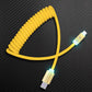 Yellow coiled USB-A to USB-C charging cable