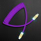 Purple coiled USB-A to Lightning charging cable with LED light
