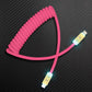 Pink coiled charging cable with gold connectors