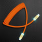 Orange coiled USB-C to USB-C charging cable