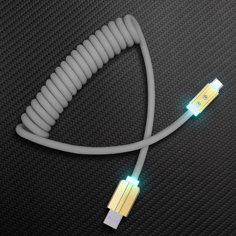 Grey coiled USB-A to USB-C charging cable with LED light