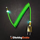Green coiled USB charging cable with glowing connector heads