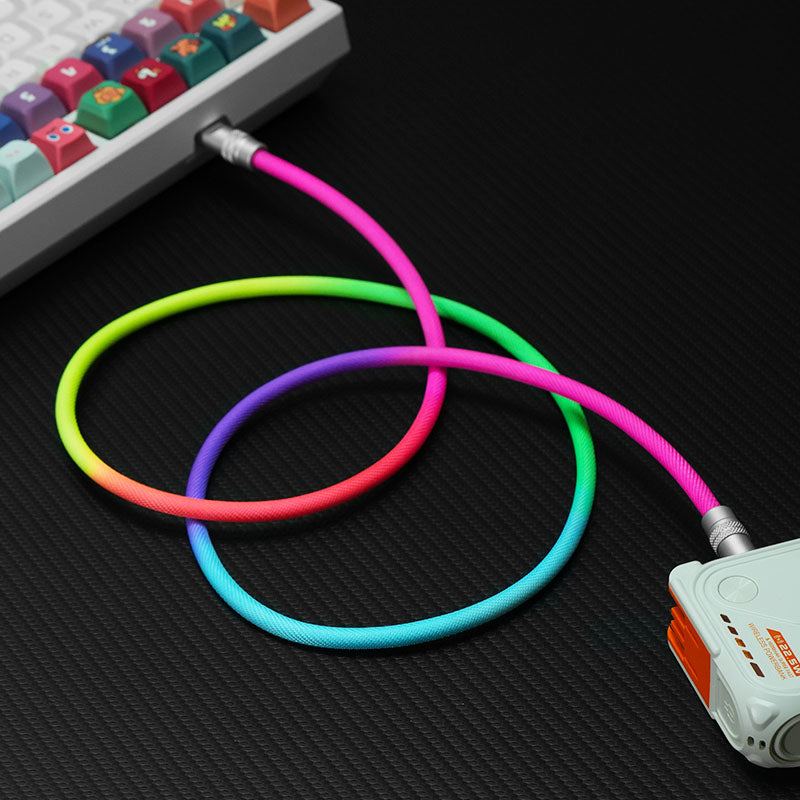 Rainbow braided fast charging cable connecting a mechanical keyboard and power bank.