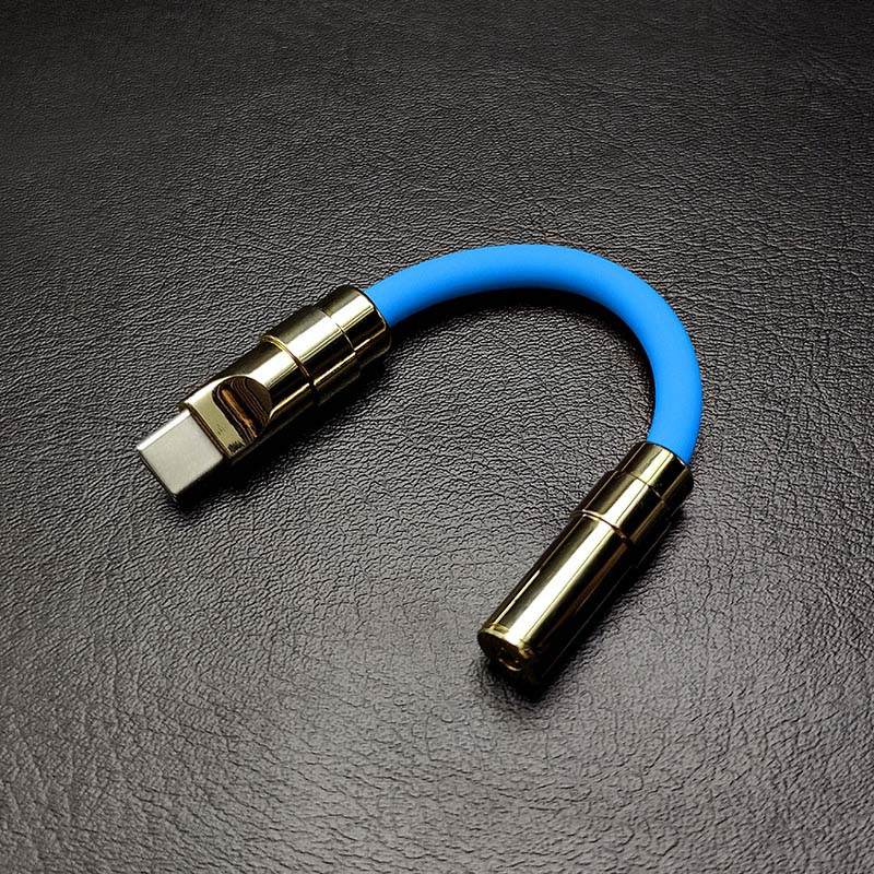 Sky blue USB-C to 3.5mm audio jack adapter with gold hardware.