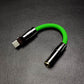 Bright green USB-C to 3.5mm headphone adapter with gunmetal hardware.