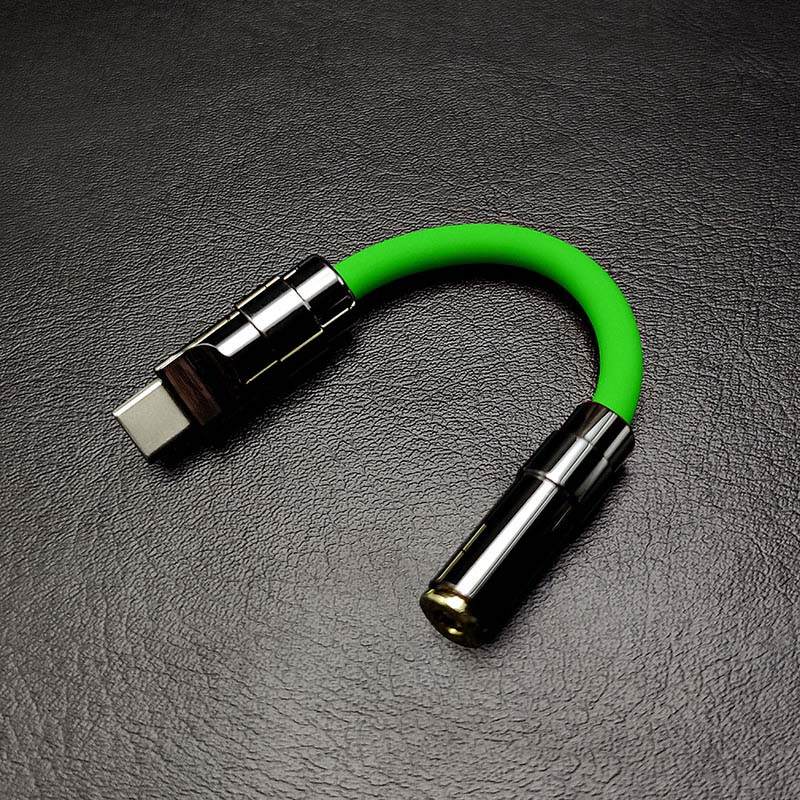 Bright green USB-C to 3.5mm headphone adapter with gunmetal hardware.