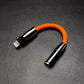 Orange Lightning to 3.5mm headphone jack adapter with black metallic shell