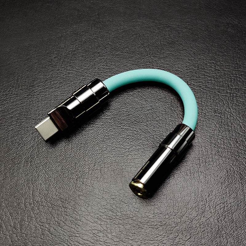 Mint green USB-C to 3.5mm headphone adapter with gunmetal hardware.