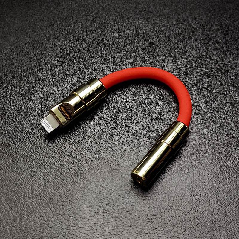 Red Lightning to 3.5mm headphone jack adapter with gold metallic shell