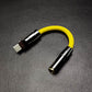 Yellow USB-C to 3.5mm headphone jack adapter with black metallic shell