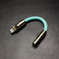 Mint green Lightning to 3.5mm headphone jack adapter with gold accents