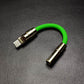 Bright green USB-C to 3.5mm audio jack adapter with gold hardware.