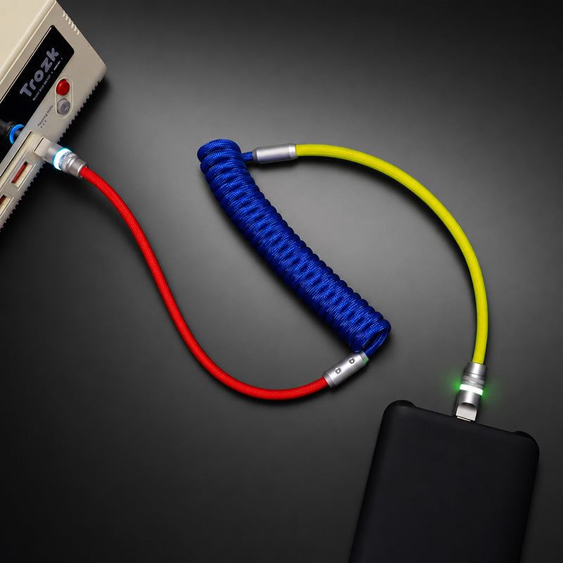 Multi-colored coiled USB cable plugged into power bank